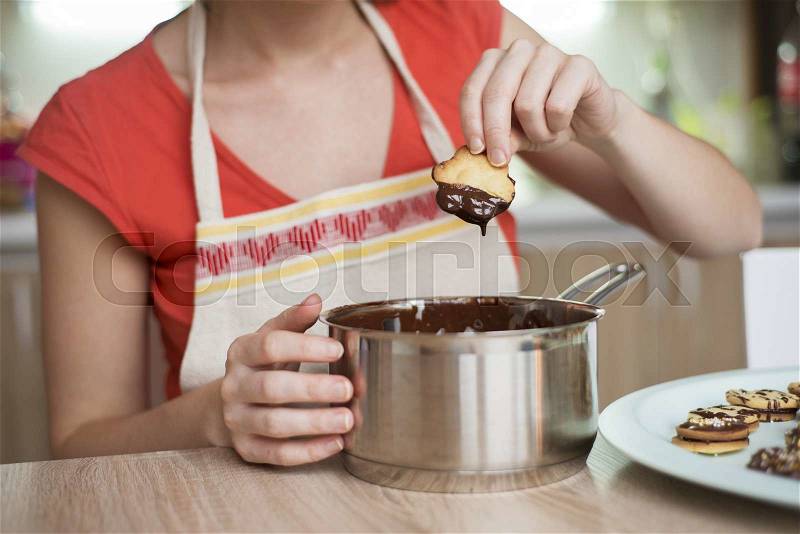 Woman is making christmas cakes in the kitchen, stock photo