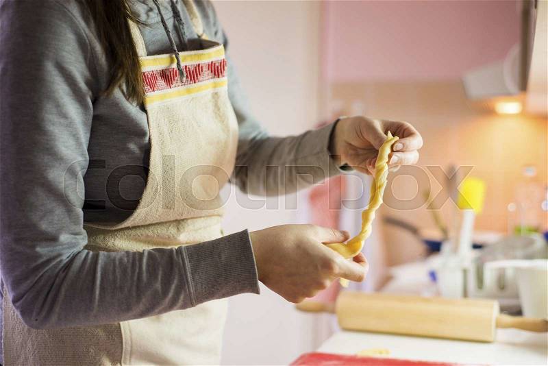 Woman in the kitchen is making holiday cake, stock photo