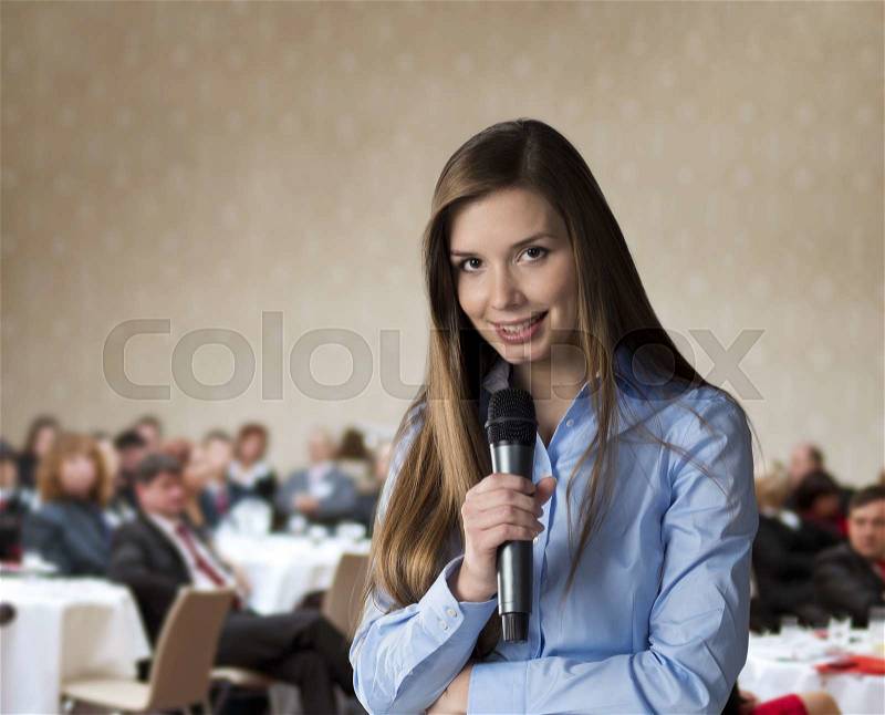 Beautiful business woman is speaking on conference, stock photo