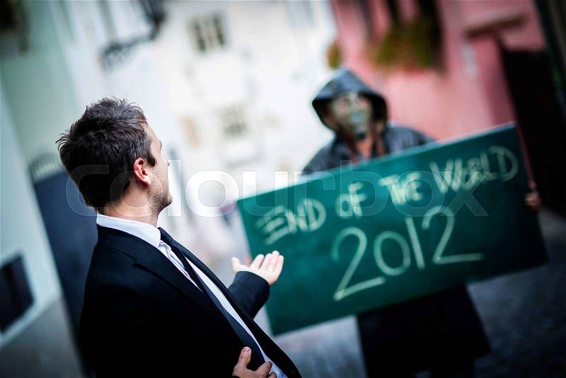 Business man is scared of the end of the world, stock photo