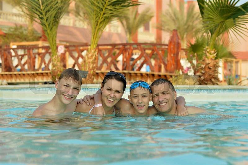 Portrait of a happy family relax in the pool, stock photo