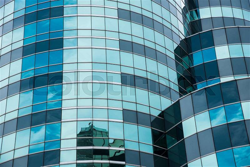 Reflecting sky in glass of office building ; abstract background, stock photo
