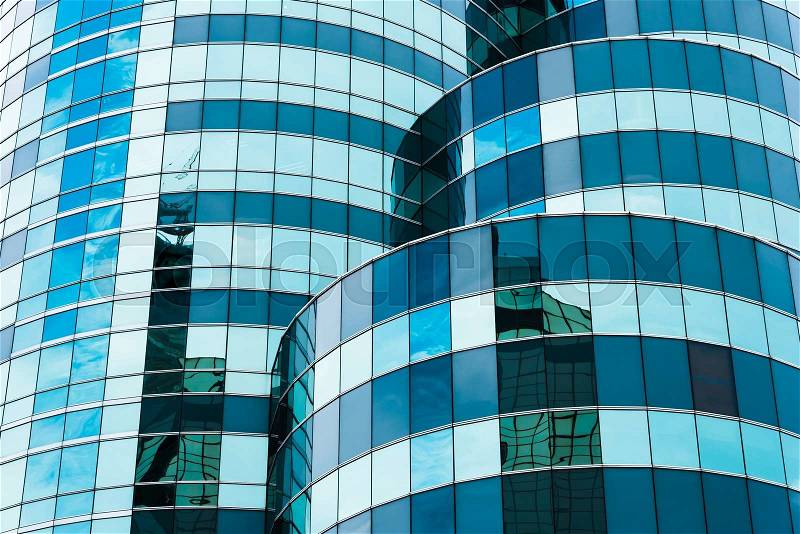 Reflecting sky in glass of office building ; abstract background, stock photo