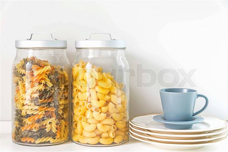 Pasta in a jar and coffee cup in kitchen, stock photo