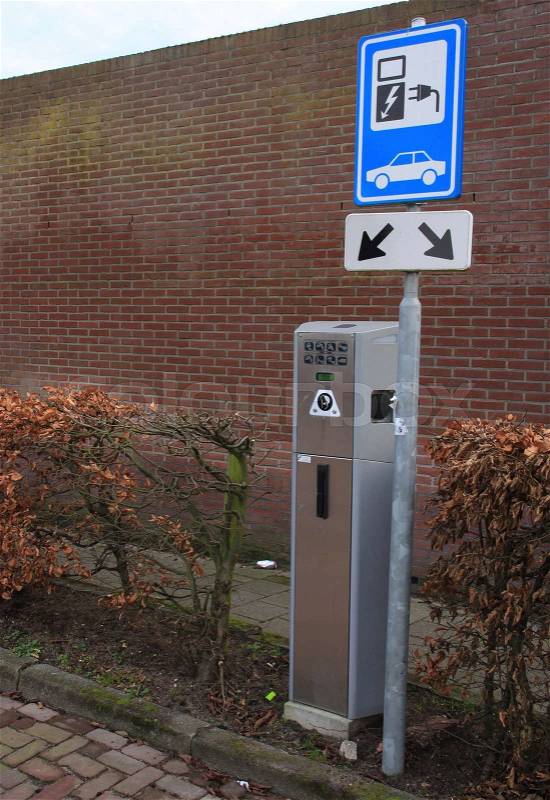 Clean energy, charging cradle for electric cars in the residential area in the village in fall, stock photo
