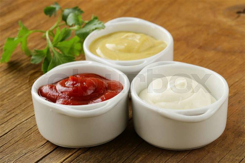 Mustard, ketchup and mayonnaise - three kinds of sauces, stock photo
