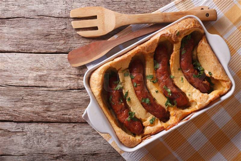 English food: toad in the hole into a baking dish on the table. Horizontal top view , stock photo
