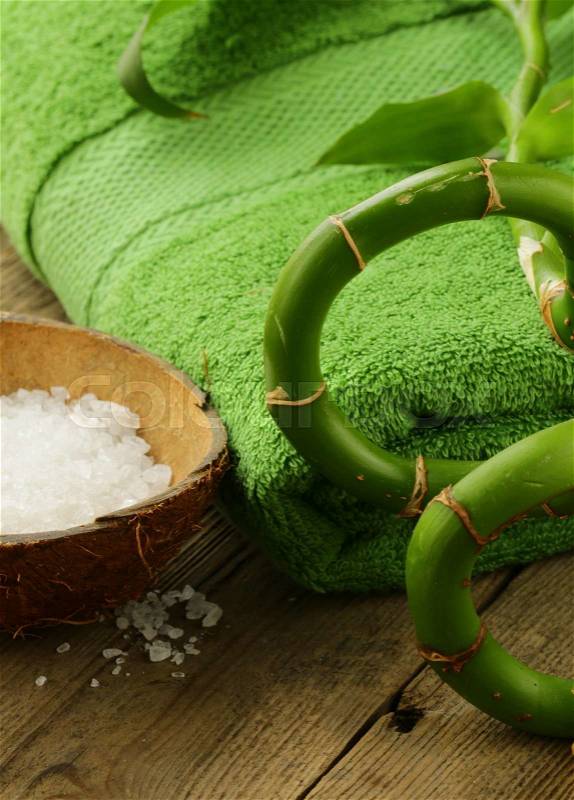 Branch of bamboo, sea salt and towel - green spa concept, stock photo