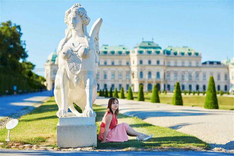 Beautiful young woman walking in Belvedere in Vienna, Austria, stock photo