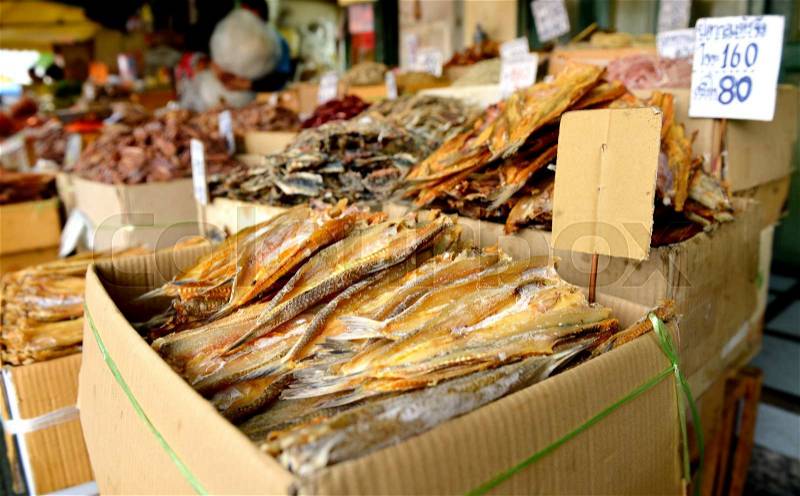 Dry fish for sale at market in paper box, stock photo