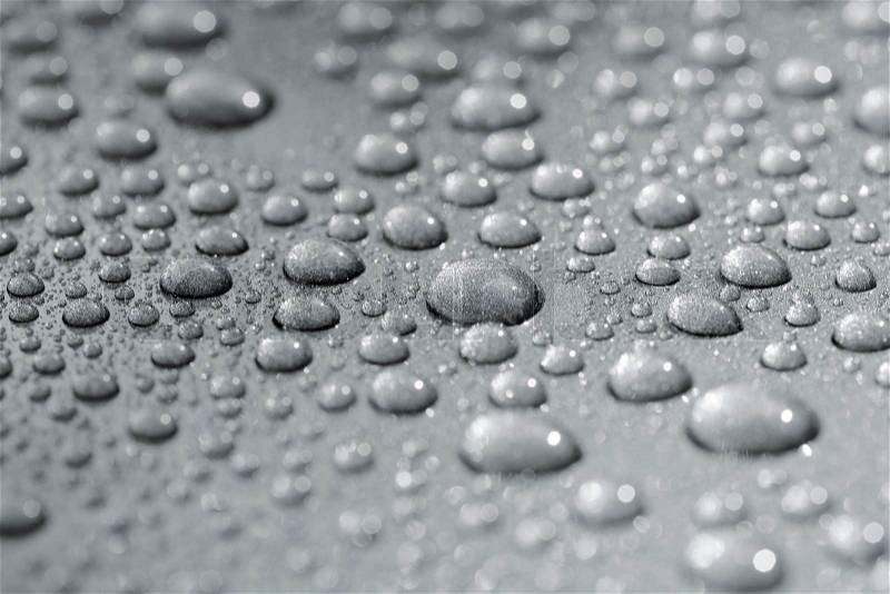 Droplets on a car. Short depth of field. The image may appear grainy, but it\'s caused by the metallic paint, stock photo