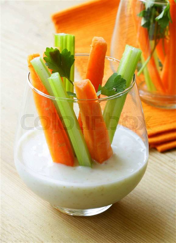 Carrots and celery with dip in a glass beakers, stock photo