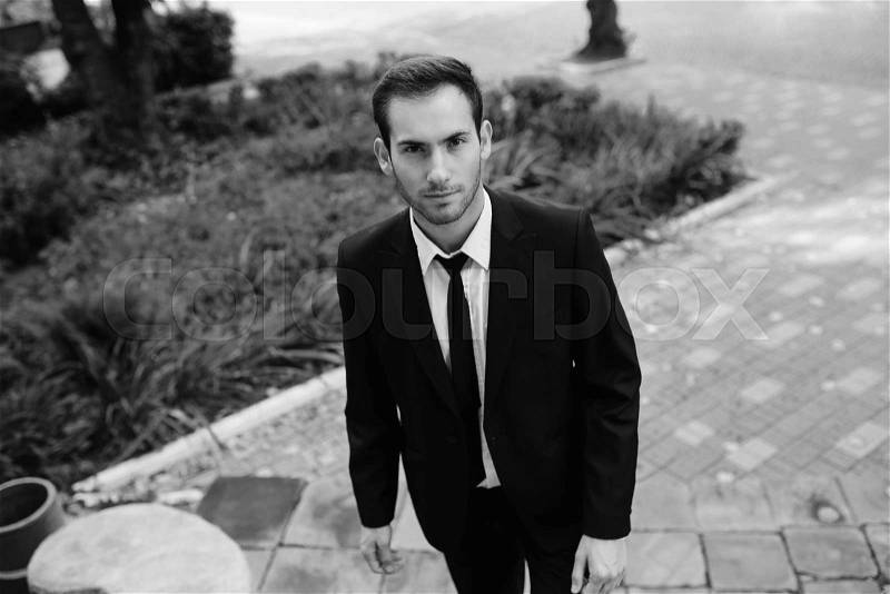 Young guy in a suit posing on the street, stock photo