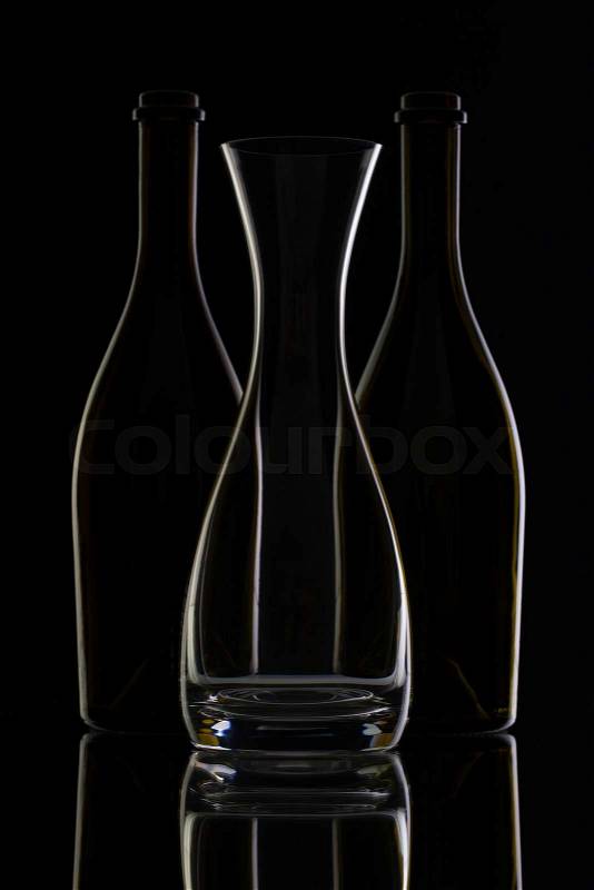 Empty glass and bottles on the black background, stock photo