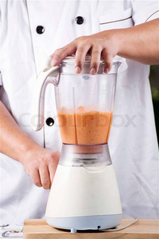 Chef making Thai Tea smoothie with blender, stock photo