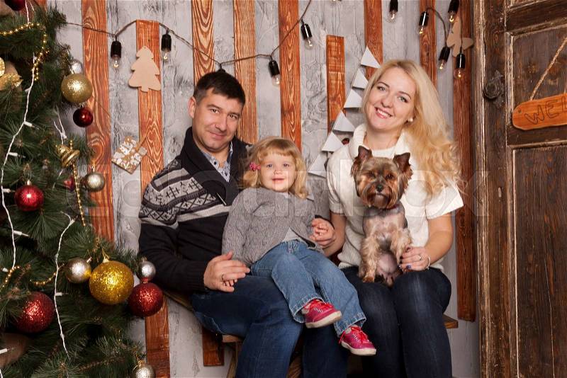Happy family with dog at home. New Year, Christmas, winter holidays, stock photo