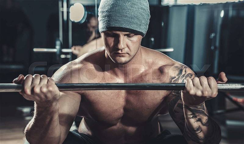 Muscular male Bodybuilder posing in studio over black, stock photo