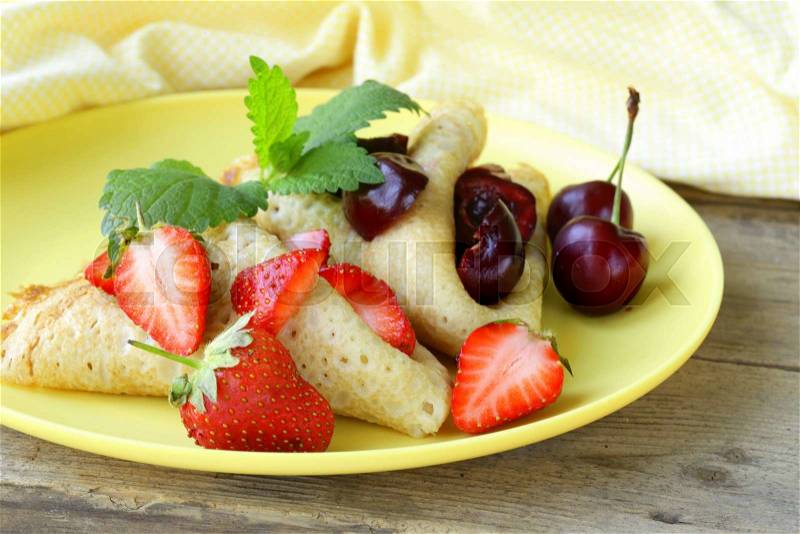 Dessert crepes with berries cherries and strawberries, stock photo
