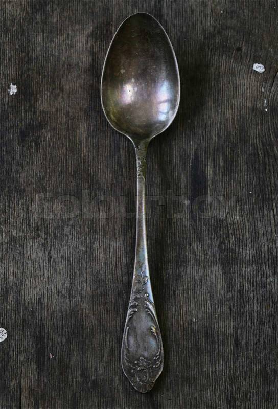 Vintage silver spoons on a wooden background, stock photo