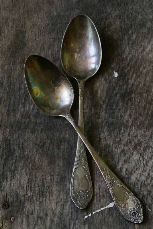 Vintage silver spoons on a wooden background, stock photo