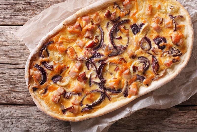 flammkuchen close-up on a paper on the table. Horizontal top view , stock photo