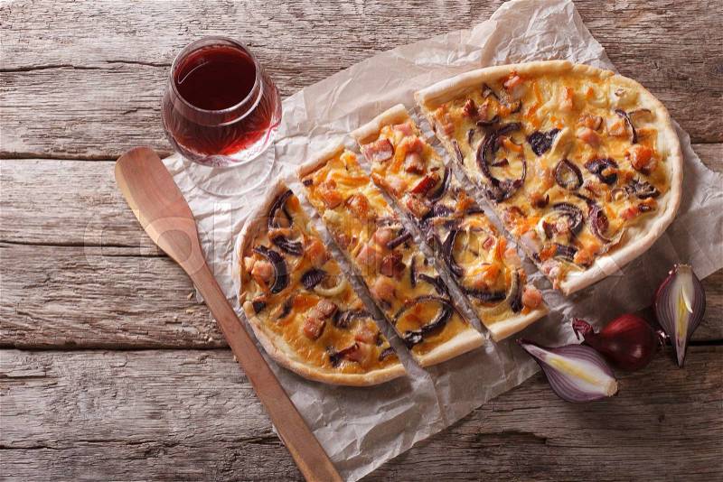 Sliced Tarte flambee and red wine on the table. horizontal top view , stock photo