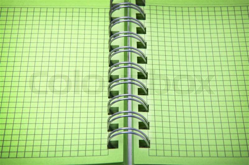 Close up shot of green notebook with focus set in center, stock photo