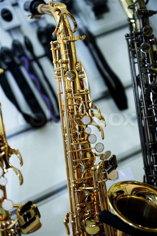 Part of a saxophone close up on the background music store, stock photo