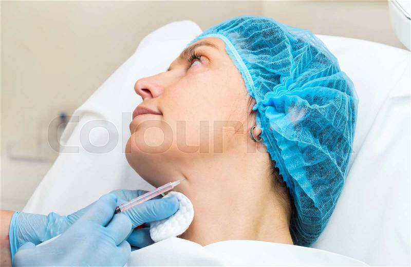 Cosmetic treatment with injection in a clinic, stock photo