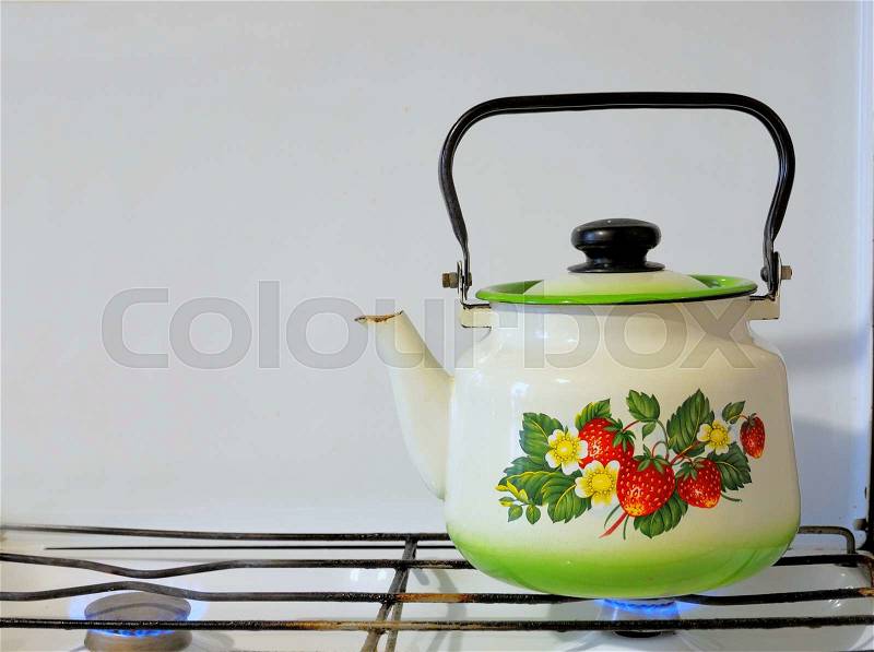 Tea kettle with boiling water on gas stove , stock photo