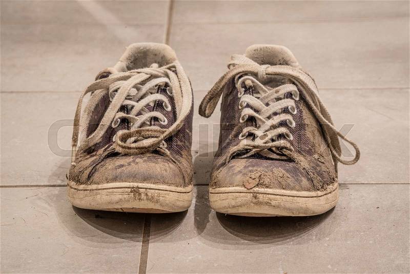 Retro shoes on the floor covered with mud, stock photo