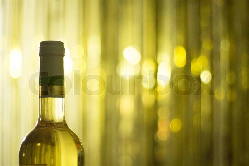 White wine bottle in restaurant at night during wedding reception party, stock photo