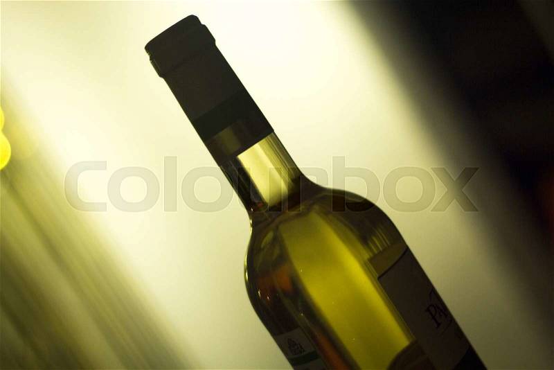 White wine bottle in restaurant at night during wedding reception party, stock photo