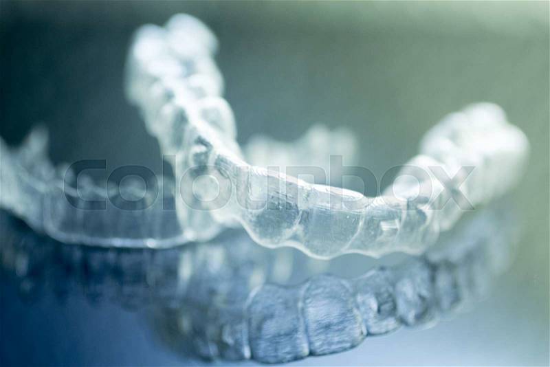 Invisible dental aligners modern tooth brackets transparent teeth braces to straighten teeth in cosmetic dentistry and orthodontics, stock photo