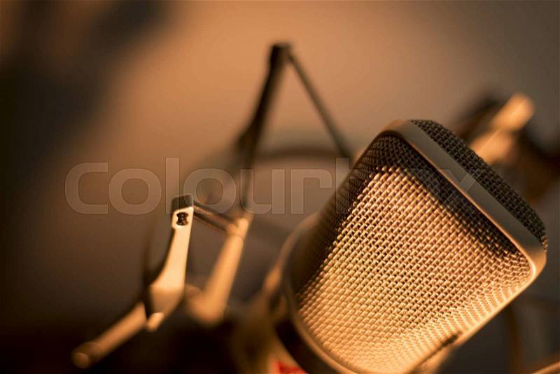 Audio recording vocal studio voice microphone with anti shock mount and built in anti pop filter for singing and voiceover actors doing voiceovers, stock photo