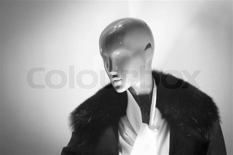 Female shop dummy fashion mannequin in department store boutique window wearing current women\'s fashions in clothes, stock photo