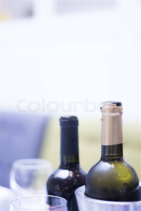 White and red wine bottles in wedding reception party dinner in restaurant photo, stock photo