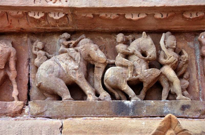 Carving of ancient warriors, elephents and horses on the battle field, stock photo
