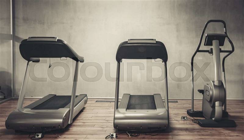 Treadmills exercise machines standing in a row in gym, stock photo