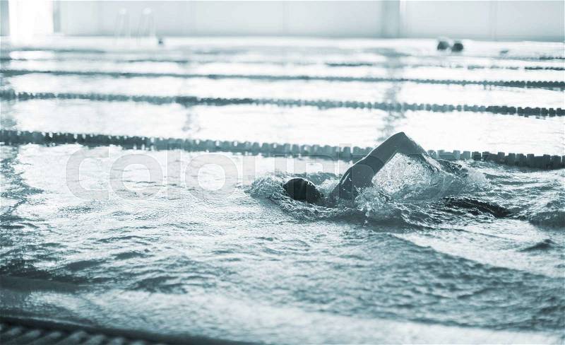 Swimmer swimming breast stroke in pool competition lane photo, stock photo