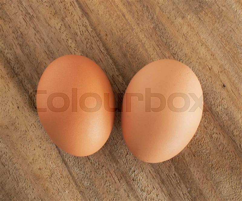 Fresh brown eggs on table, stock photo