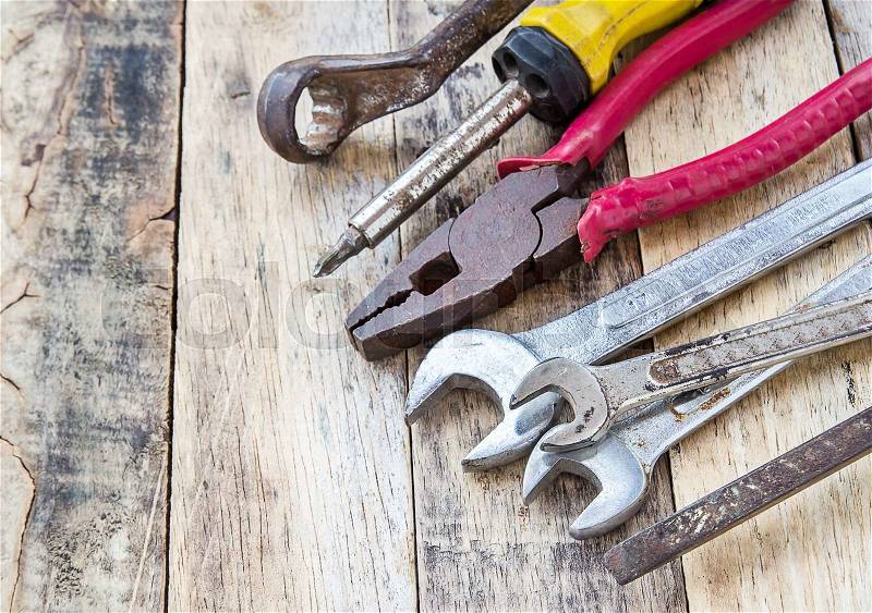 Close up bunch of used tools on wooden table background, stock photo