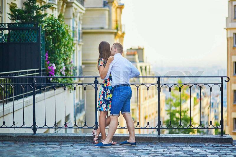 Young romantic couple having a date on a street of Montmartre in Paris, France, stock photo