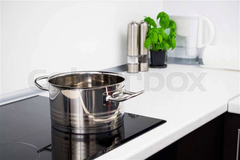 Pot in modern kitchen with induction stove, stock photo