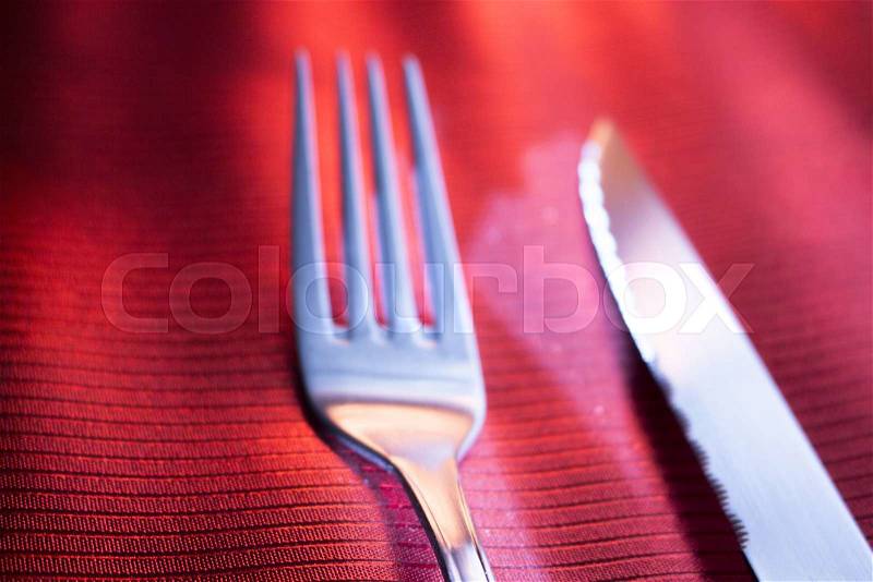 Knife and fork on dinner table place setting in restaurant wedding party photo, stock photo
