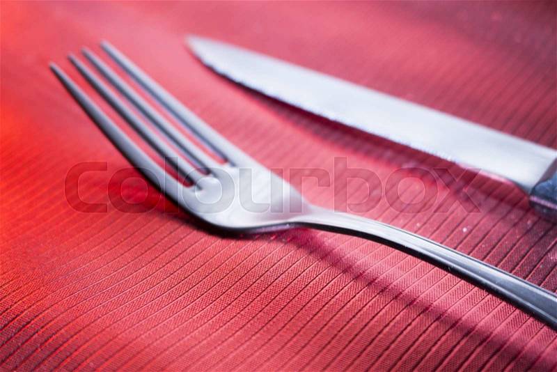 Knife and fork on dinner table place setting in restaurant wedding party photo, stock photo