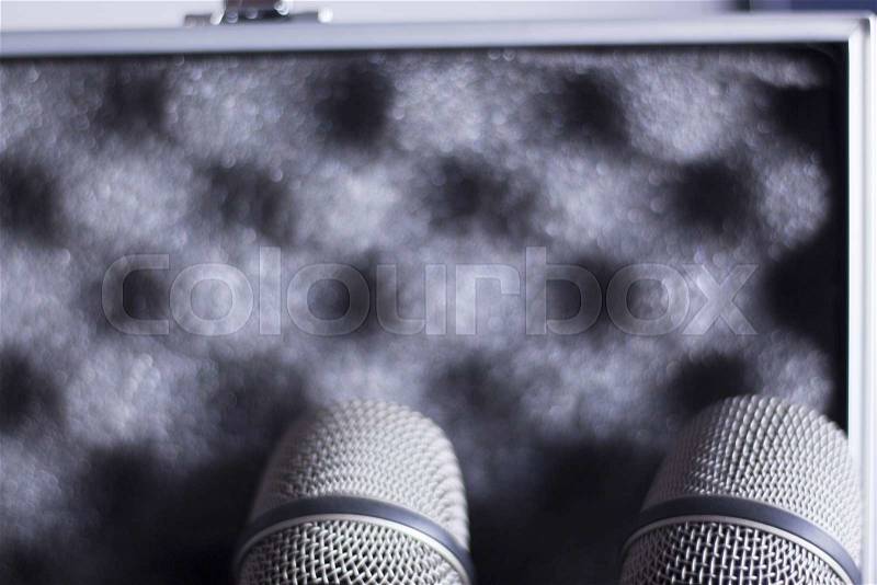 Audio recording vocal studio professional microphones and hard metal and foam insert carry case to record singing or voice-overs, stock photo