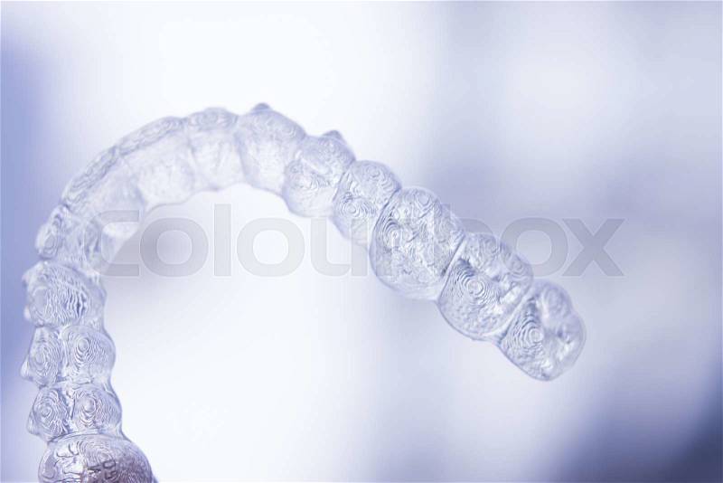 Invisible dental aligners modern tooth brackets transparent teeth retainer braces to straighten teeth in cosmetic dentistry and orthodontics, stock photo