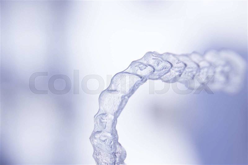 Invisible dental aligners modern tooth brackets transparent teeth retainer braces to straighten teeth in cosmetic dentistry and orthodontics, stock photo