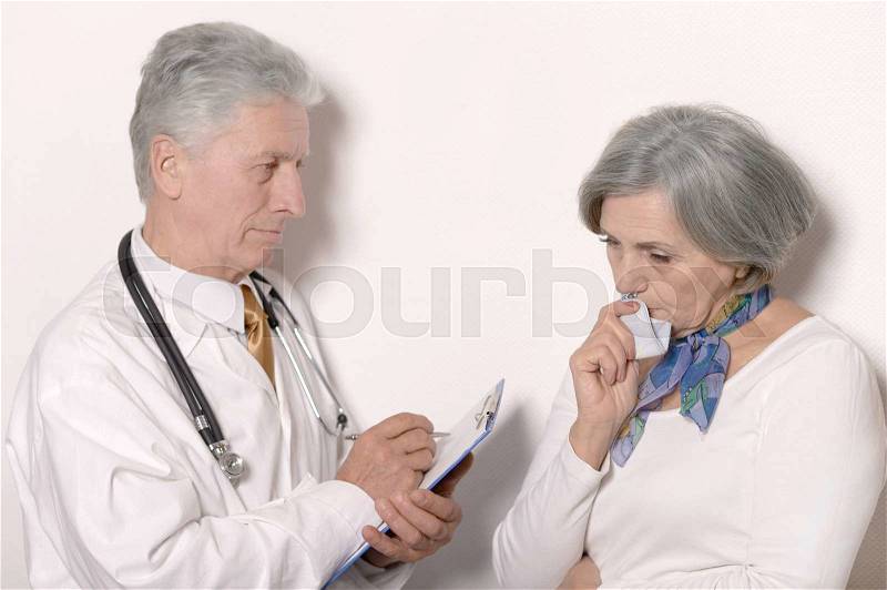 Senior woman visiting doctor at hospital on white background, stock photo